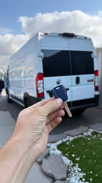 Key held in front of a white cargo van