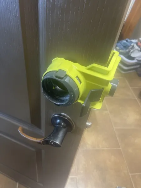 Door boring jig clamped to a front door to drill the hole for a new deadbolt