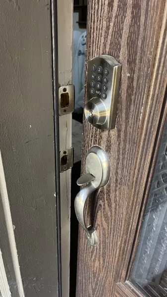 eufy keypad deadbolt and lever handleset on a wood-grain front door