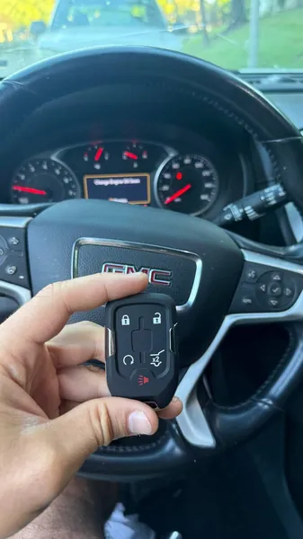 GMC smart key held in front of the steering wheel