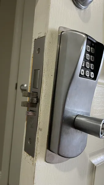 Push-button keypad lever lock with its mortise lock body on an office door