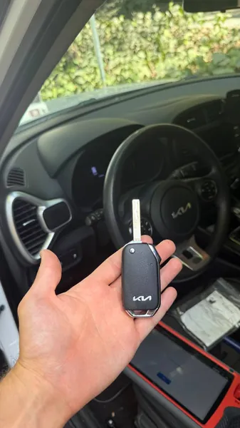Kia flip key held in front of the steering wheel