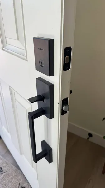 Matte black handleset and deadbolt on a white front door