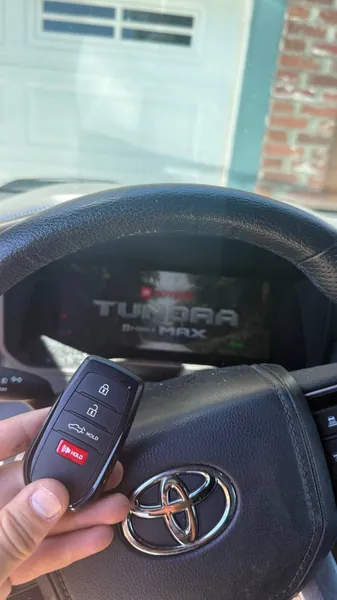 Toyota smart key held at the wheel of a Tundra